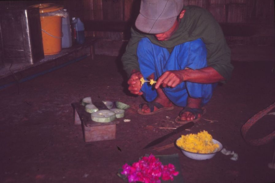 A Lisu man is preparing flowers for the harvest festival. EFEO_KLEO00035
